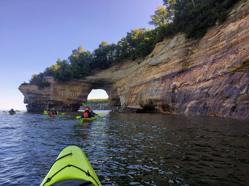 Kayaking along cliffs in Pictured Rocks National Lakeshore