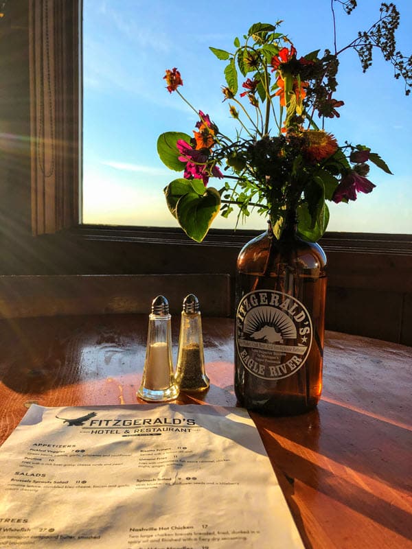 Image of menu and vase of flowers at Fitzgerald's Restaurant in Eagle River, MI