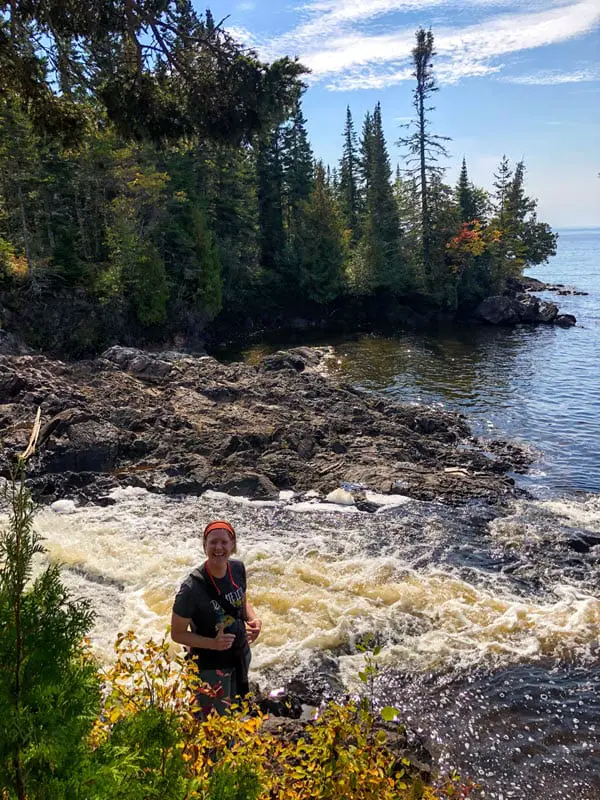 Image of author standing in front of Montreal Falls as it spills into Lake Superior
