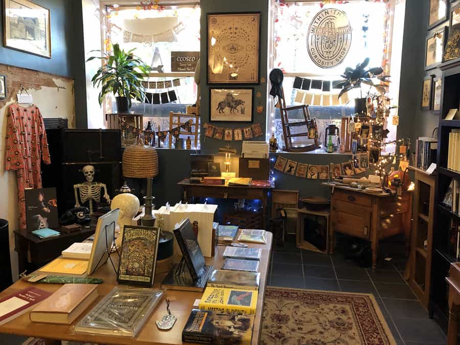 Image of inside of the store Within Things. Shows books and wall decor