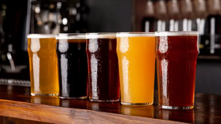 Image of five pints of beer that range from light to dark beer