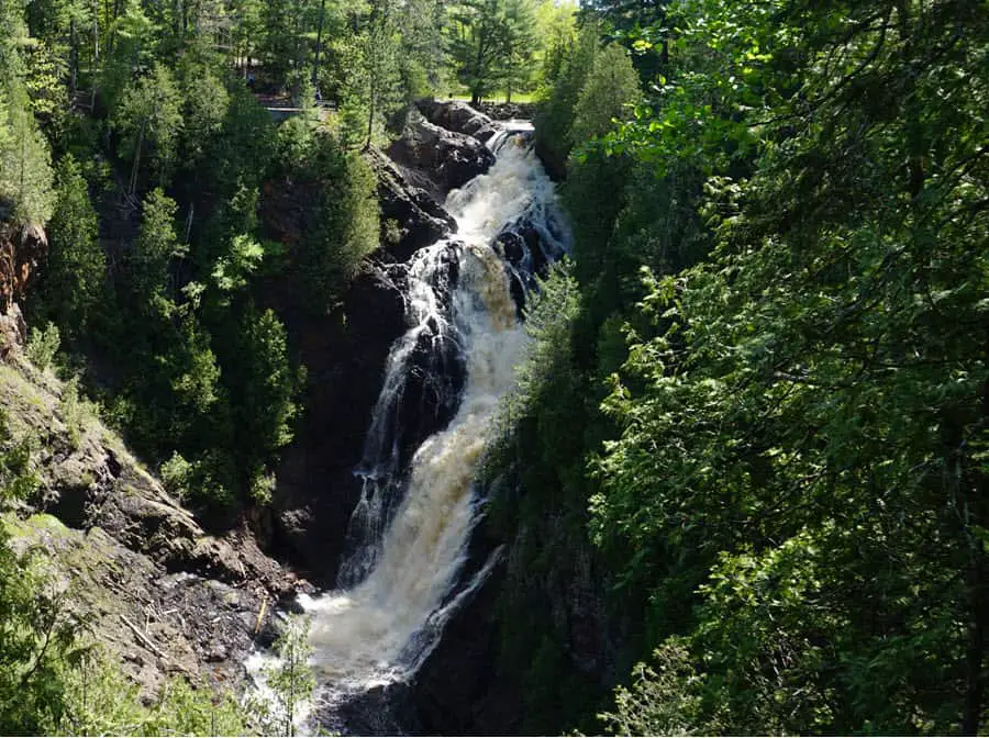 Image of Big Manitou Falls in Pattison State Park. Falls surrounded by green trees