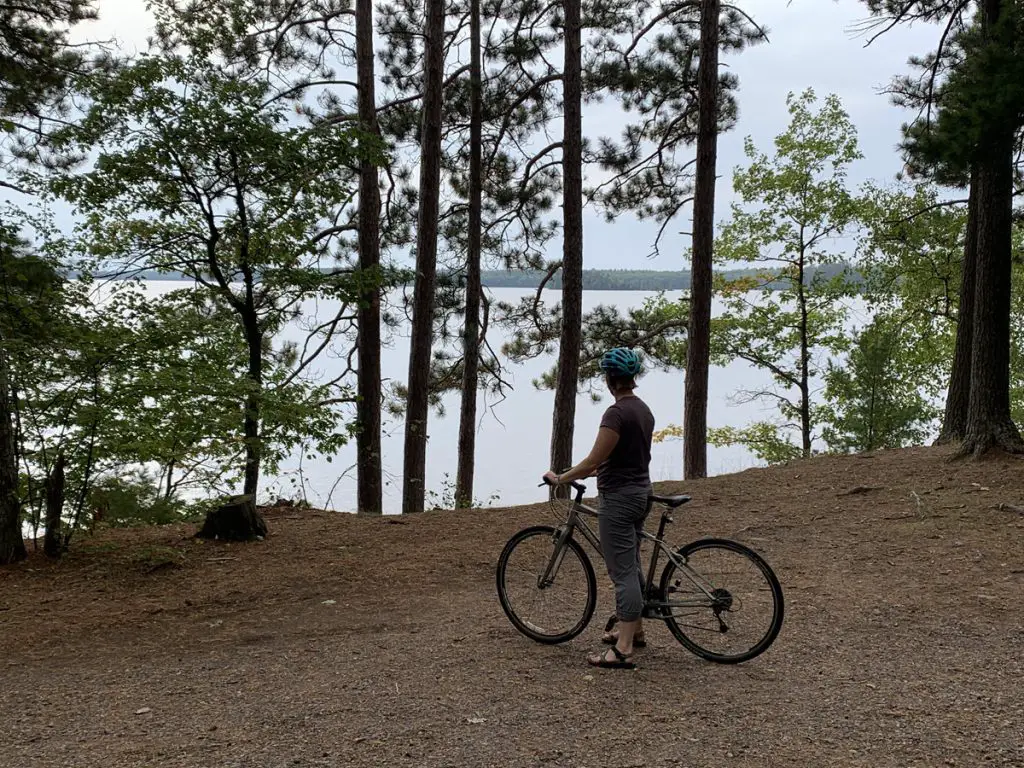 Image of biker looking out at Trout Lake in Boulder Junction WI