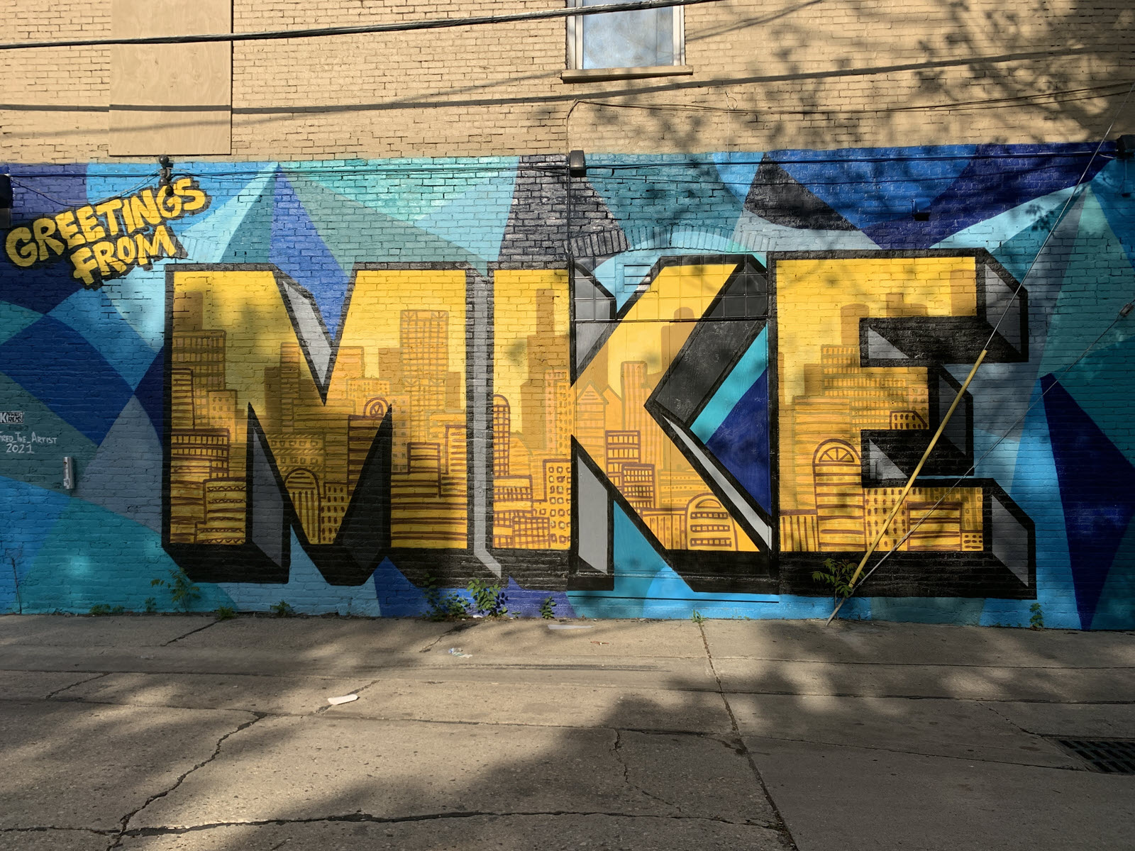 Image of mural that reads "Greetings from MKE"