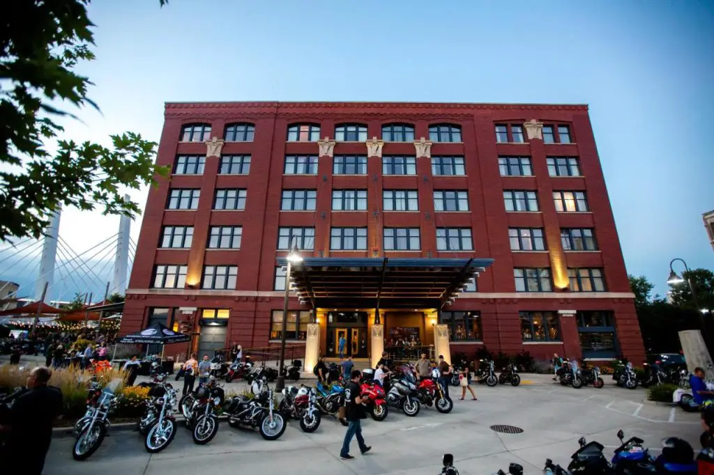 Image of the exterior of The Iron Horse Hotel in Milwaukee WI. About 20 motorcycles are parked out front