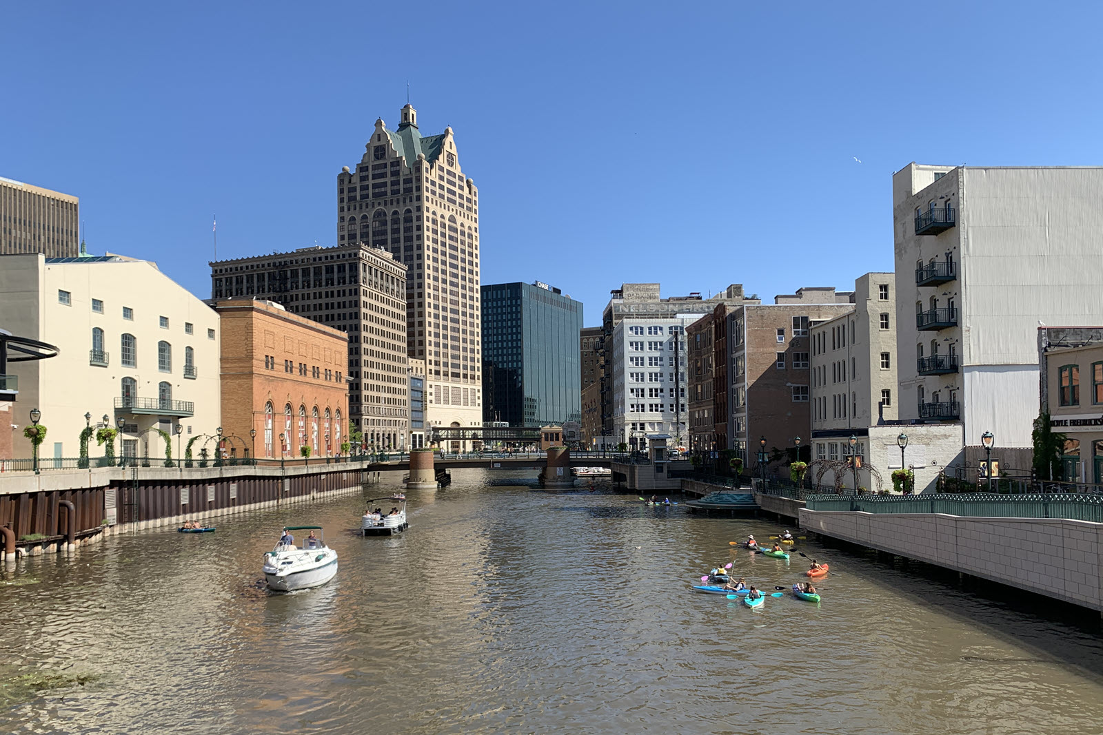Image of Milwaukee River with boats and kayaks on it