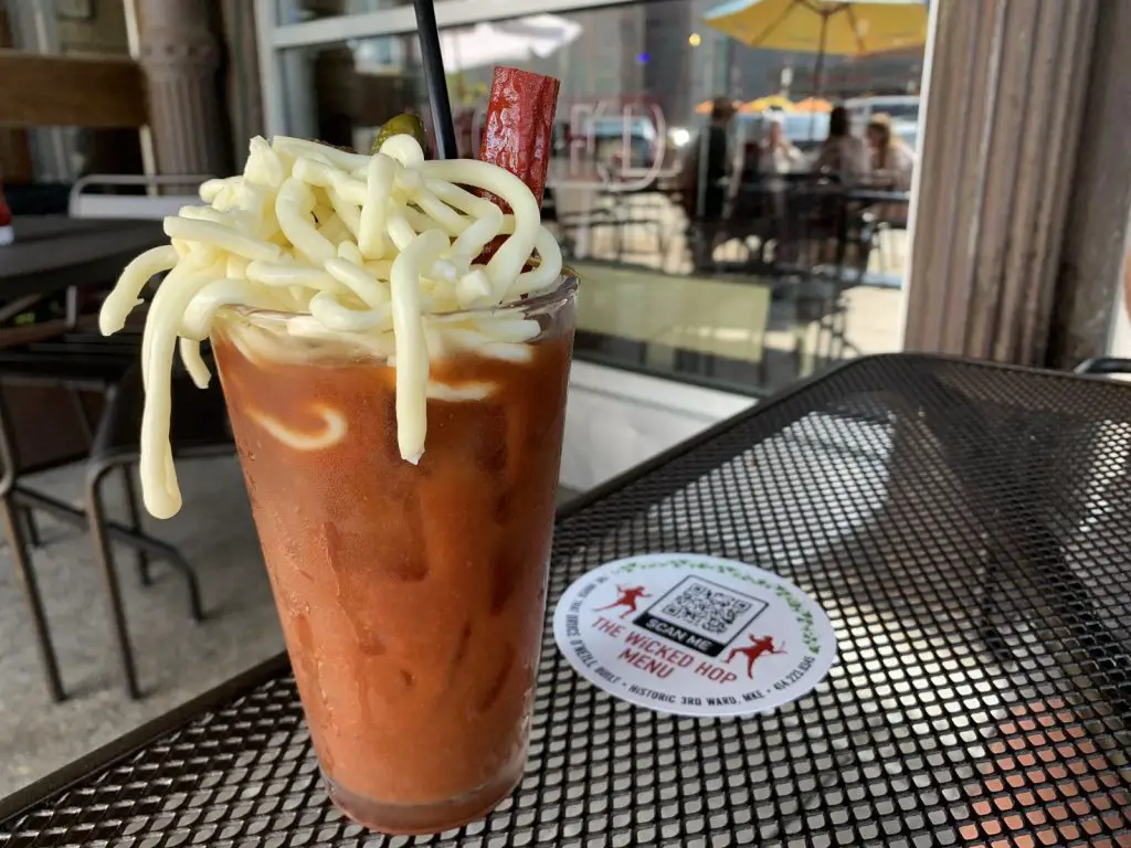 Image of a Bloody Mary drink with string cheese and a beef stick
