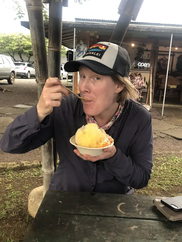 Mel eating shaved ice outside of a store on the North shore of Kauai