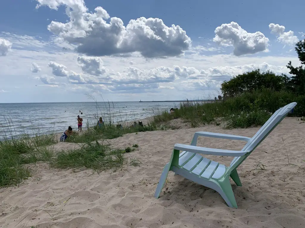Image of Neshotah Beach in Two Rivers WI with adirondack chair in foreground