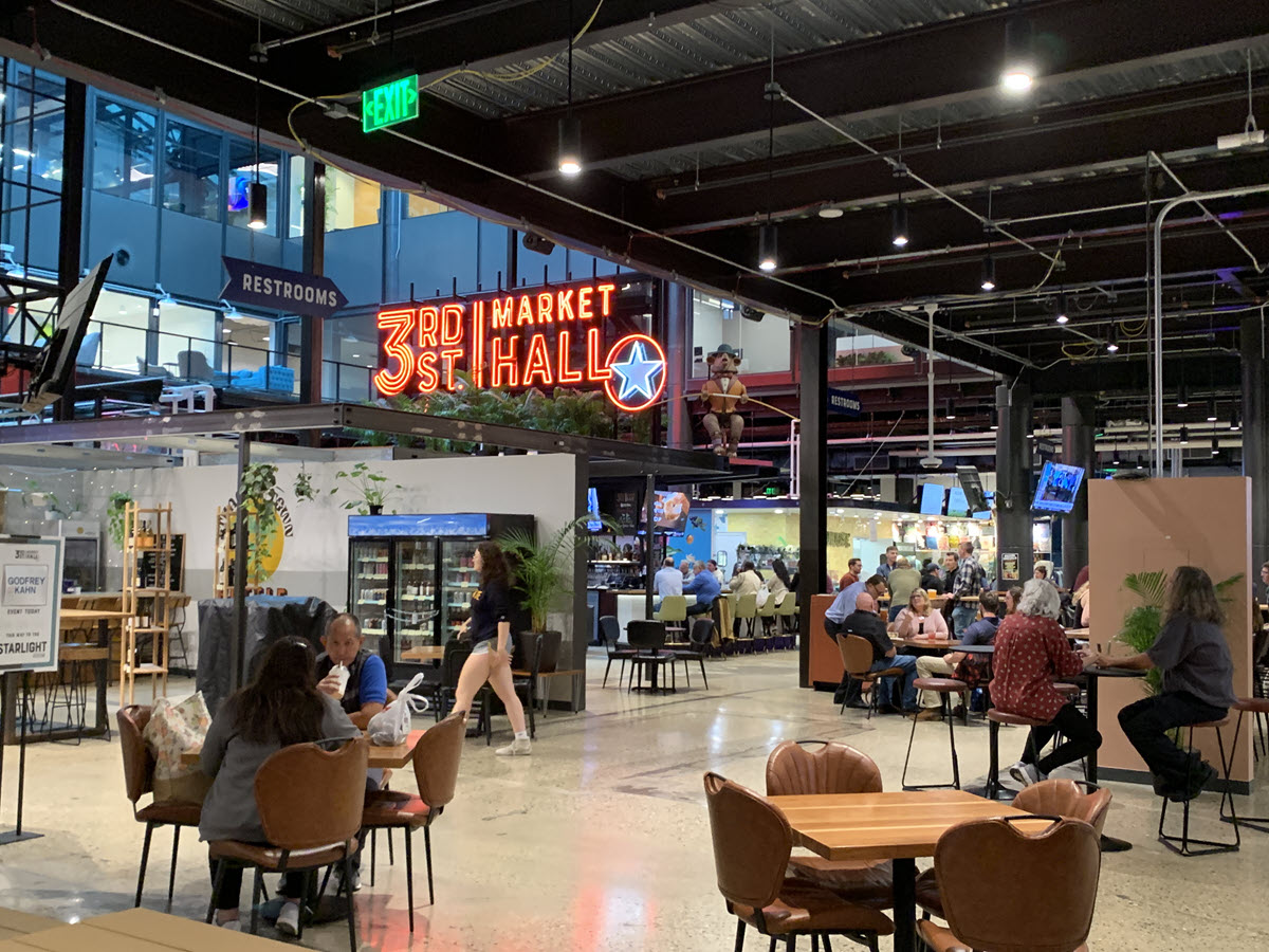 Image of inside of 3rd Street Market Hall with people sitting at tables